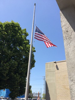 flag at half staff in honor of Stan Loula